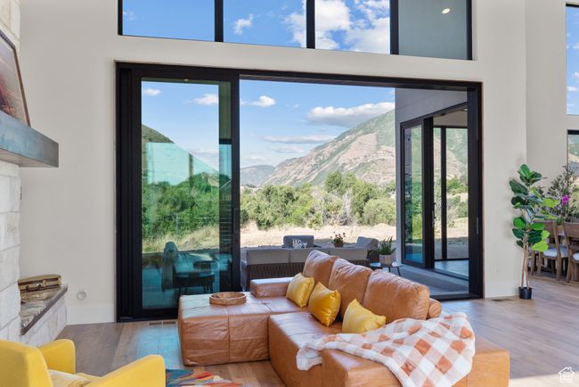 Living room featuring a mountain view and wood finished floors | Image 13