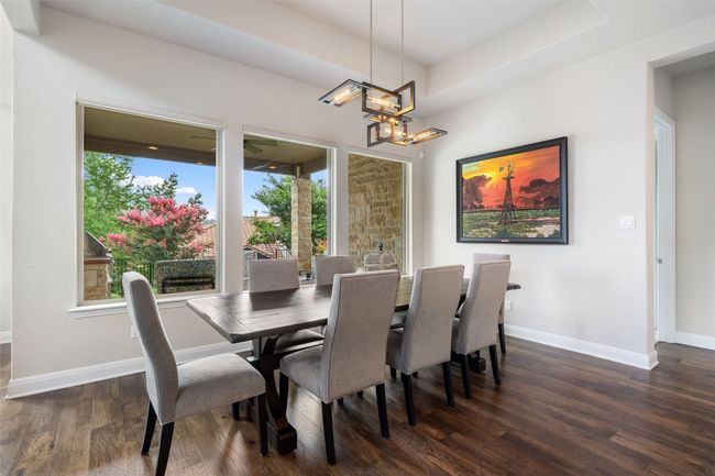 Dining room featuring dark wood finished floors and a chandelier | Image 12