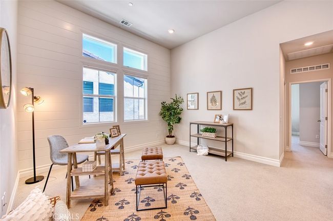 Bright and versatile 2nd floor loft with shiplap accents and high ceilings. | Image 11