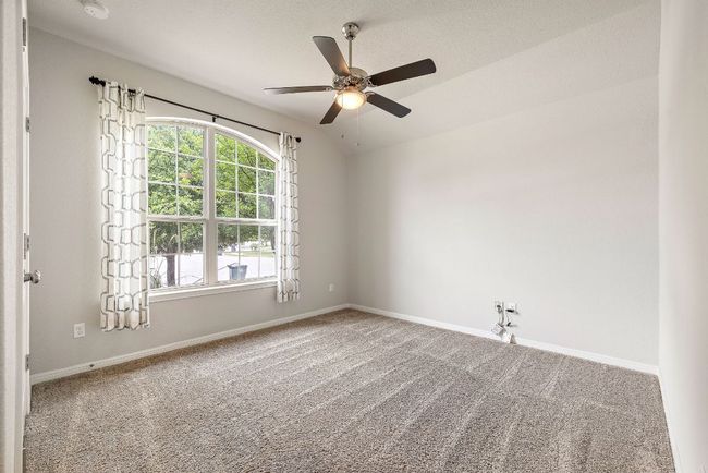 Unfurnished room with ceiling fan, carpet floors, lofted ceiling, and baseboards | Image 21