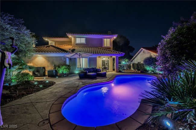 Pool at night with lights and outdoor lounge area | Image 66