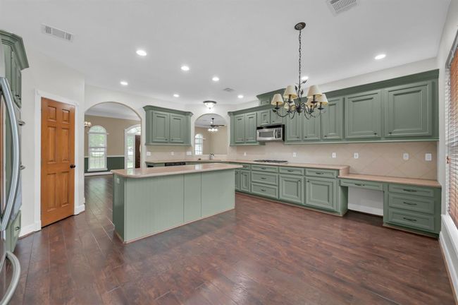 Breakfast area on the right and kitchen on the middle. Pantry on the left. | Image 15