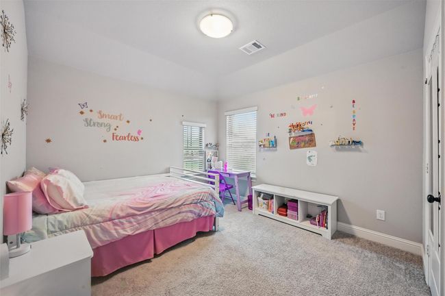 Carpeted bedroom featuring vaulted ceiling and baseboards | Image 34
