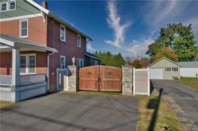 View of side of home featuring an outbuilding and a garage | Image 3