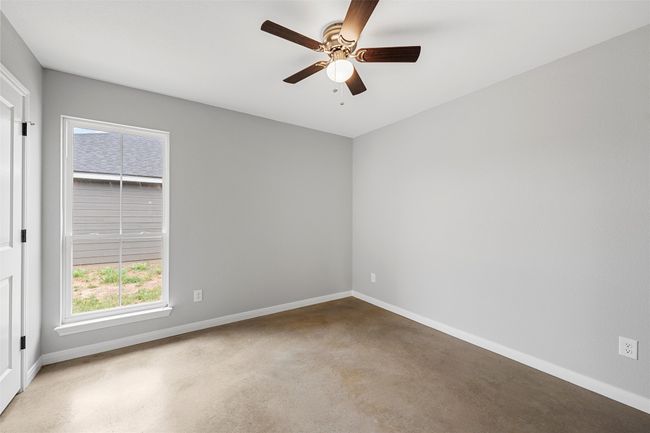 Empty room featuring ceiling fan and baseboards | Image 7