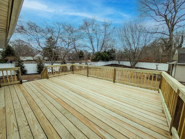 View of yard featuring a garage, a fenced backyard, a storage unit, and an outbuilding | Image 27