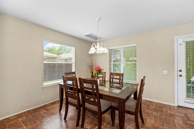 Dining area featuring a chandelier and stone finish flooring | Image 12