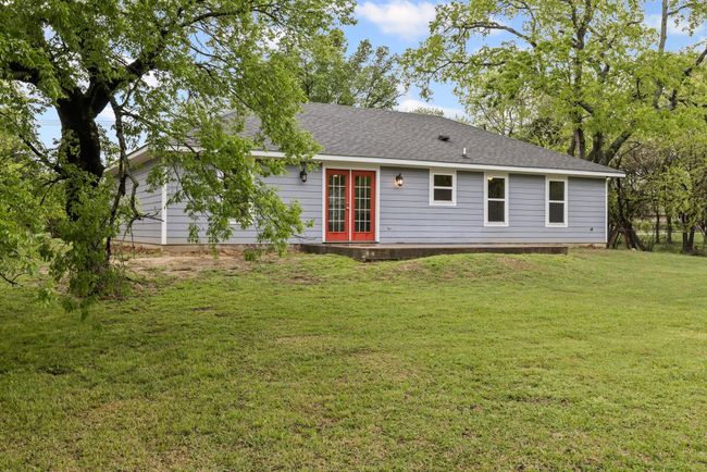 Back of house with french doors, roof with shingles, and a lawn | Image 28