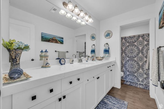 Bathroom with wood finished floors, vanity, and toilet | Image 20