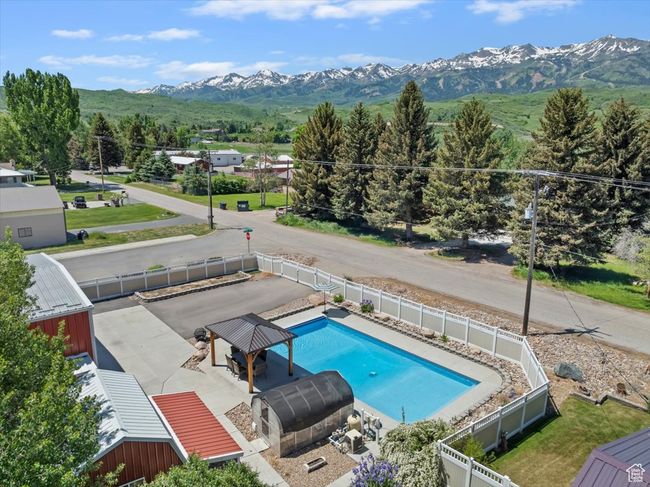 View of pool with a fenced backyard and a mountain view | Image 38