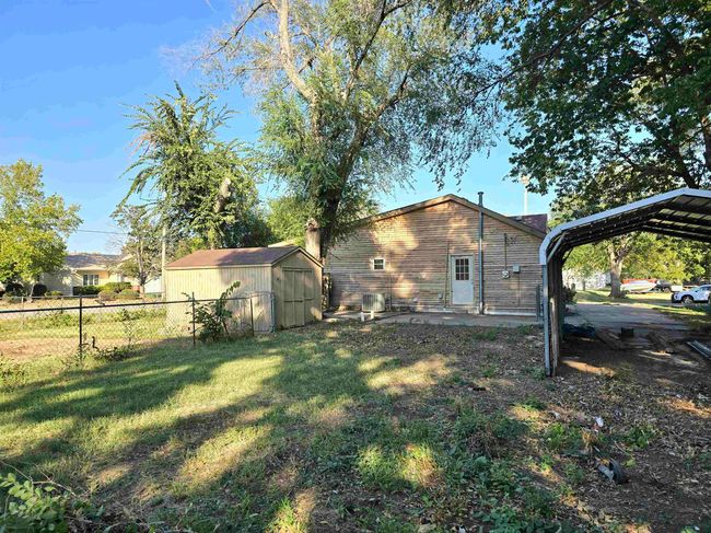 View of yard with a carport and a shed | Image 21