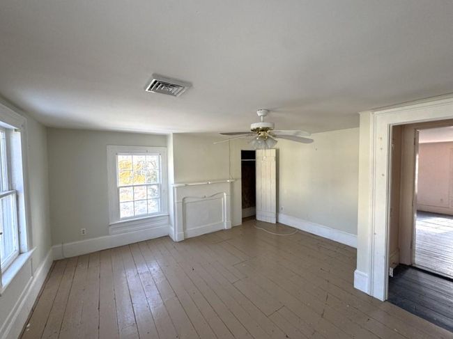 Bedroom with ceiling fan, and wood finished floors | Image 7