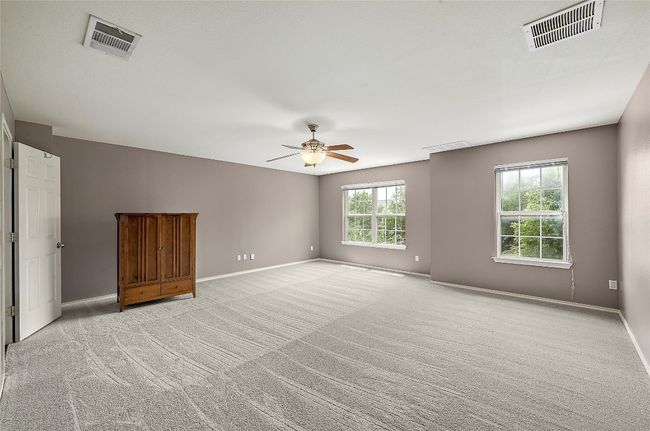 Unfurnished room featuring ceiling fan and light colored carpet | Image 17