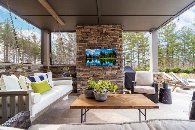 The poolside covered patio area provides shade and relaxation. | Image 29