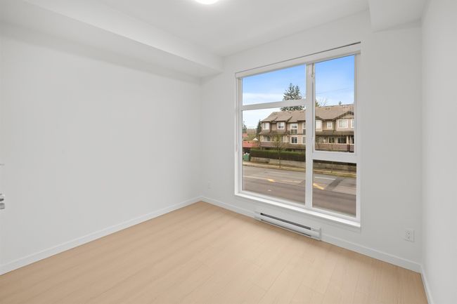Empty room featuring baseboard heating and wood finished floors | Image 15