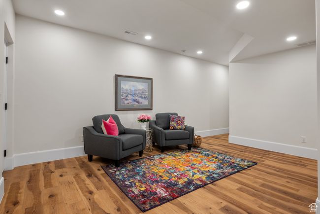 Living area with wood finished floors and recessed lighting | Image 56