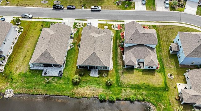 Aerial perspective of suburban area featuring a large body of water | Image 9