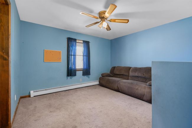 1 of 3 bedrooms, features a closet, window and ceiling fan | Image 14