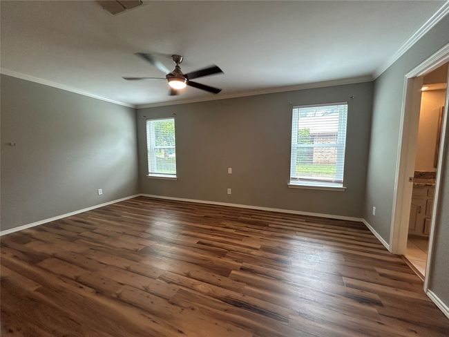 Unfurnished room featuring ornamental molding, dark wood-type flooring, and ceiling fan | Image 22