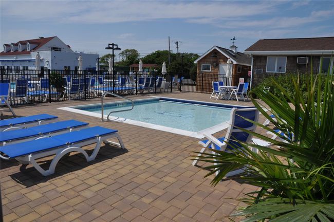 Community pool with a patio and fence | Image 19