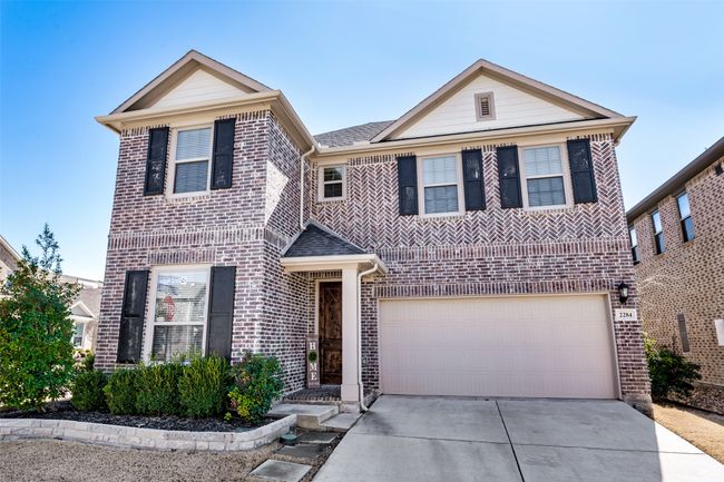 View of front facade with a garage, driveway, and brick siding | Image 33