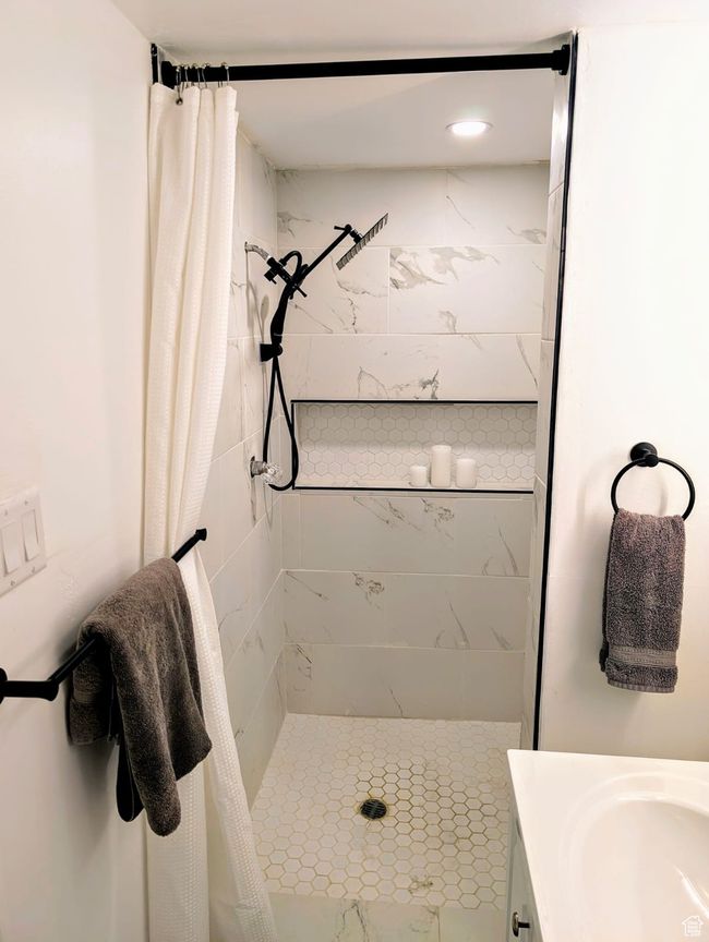 Bathroom featuring a stall shower and vanity | Image 6