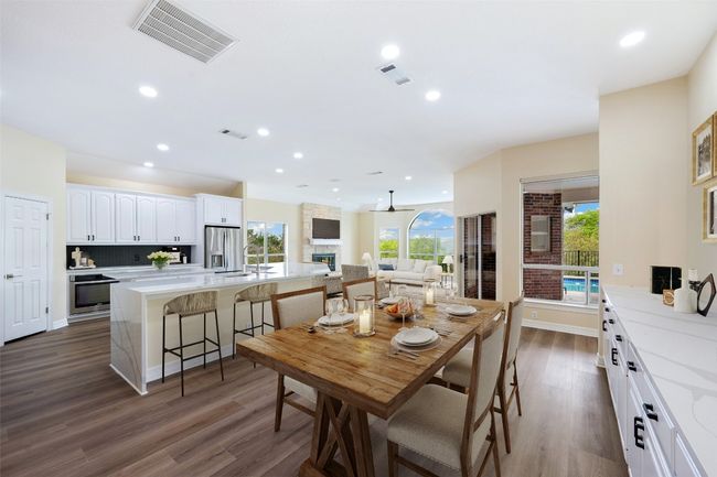 Kitchen features large breakfast area and built-in sideboard storage. Virtually staged. | Image 13