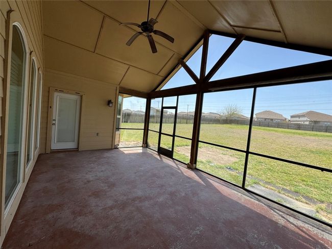 Unfurnished sunroom featuring lofted ceiling and ceiling fan | Image 20
