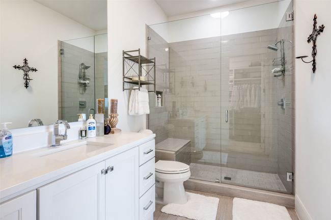 The ensuite full bath from the guest primary bedroom with large shower | Image 29