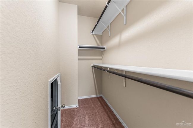 Walk in closet with dark carpet | Image 23