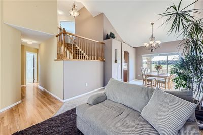 Spacious living room with vaulted ceilings opens to the dining room with golf course views! | Image 2