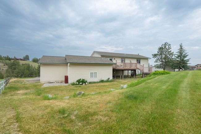 Rear view of property with a deck and a yard | Image 31