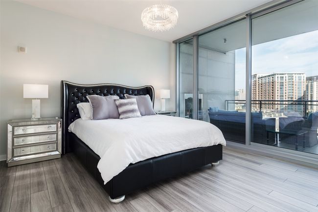 Primary bedroom with balcony access. | Image 8