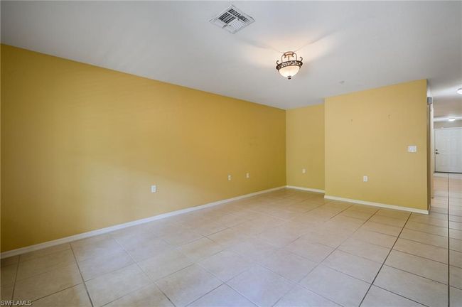 Empty room featuring light tile patterned floors | Image 6