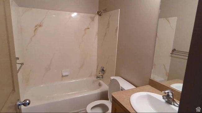 Bathroom featuring toilet, bathtub / shower combination, and vanity | Image 38