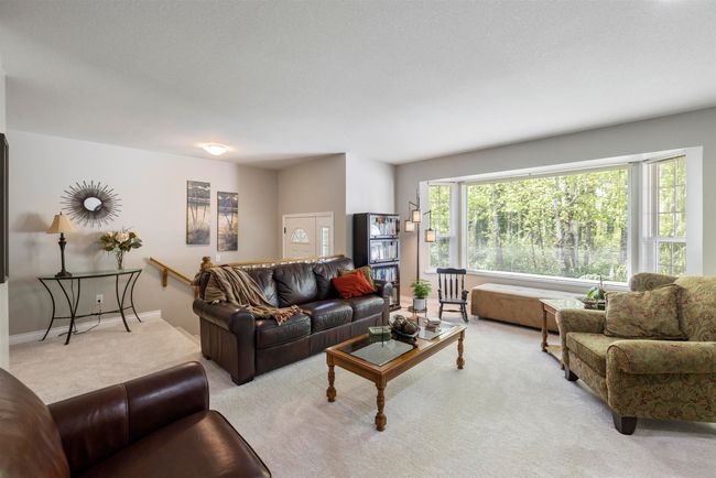 Carpeted living room with baseboards | Image 5