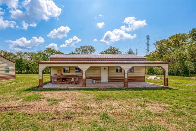 Echoing the main home’s shape, this unfinished structure features a generous front porch and is poised for transformation—already framed, plumbed, and full of potential. | Image 29