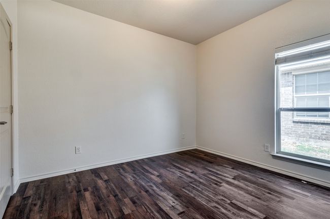Unfurnished room with dark wood-style floors and baseboards | Image 16