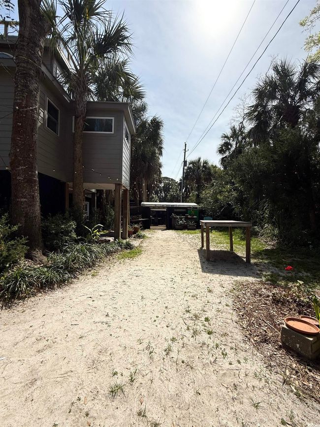 View of yard with a carport and dirt driveway | Image 38
