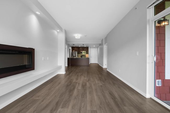 Corridor with dark wood-style flooring and baseboards | Image 24