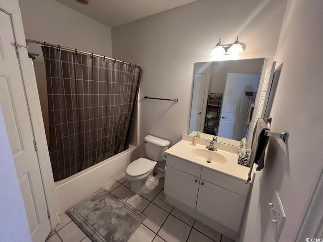 Full bath with vanity, tile patterned flooring, and shower / tub combo | Image 9