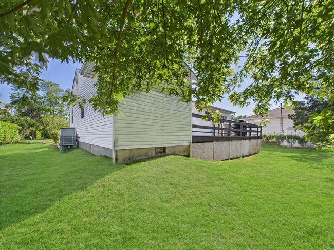 View of green lawn featuring a deck | Image 33