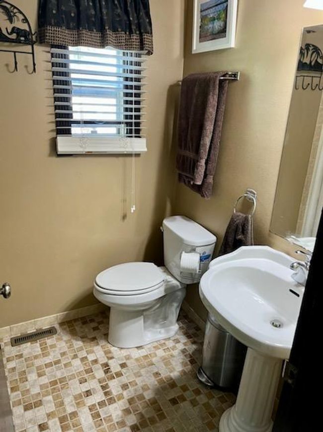 The dining room has hardwood flooring. There is a remodeled 3/4 bathroom through the door on the right. this could easily be made into a main floor bedroom. | Image 9