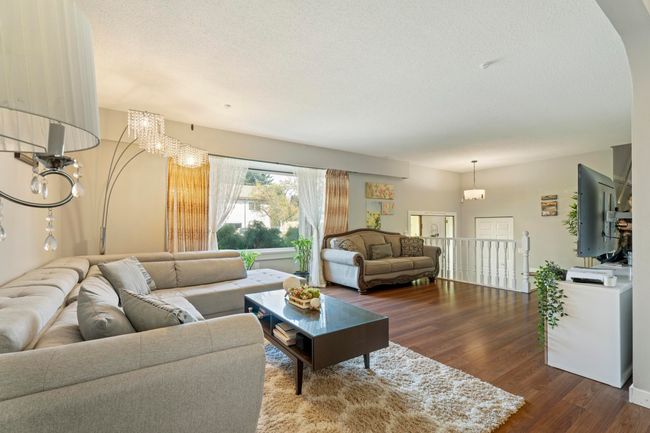 Living room featuring dark wood-type flooring and a textured ceiling | Image 9