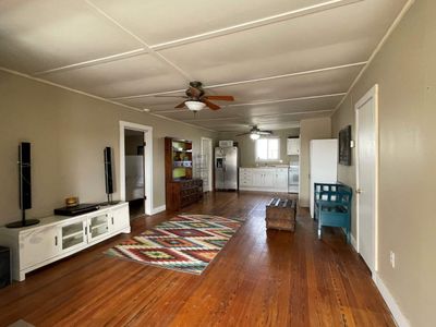 Unfurnished living room featuring dark hardwood / wood-style floors and ceiling fan | Image 3