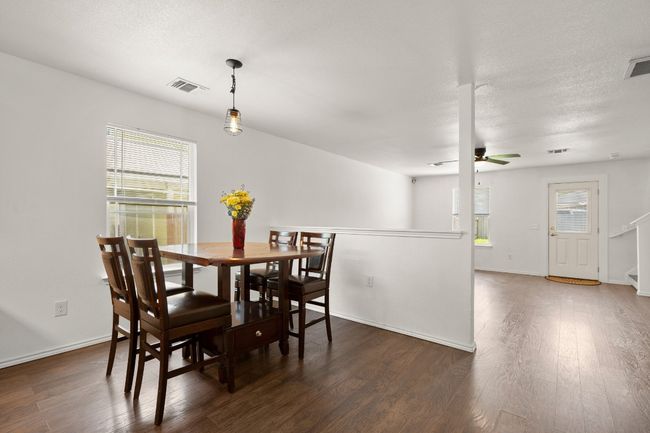 Spacious and bright dining room with open flow to both kitchen and living room. Enjoying cooking meals while entertaining. | Image 6