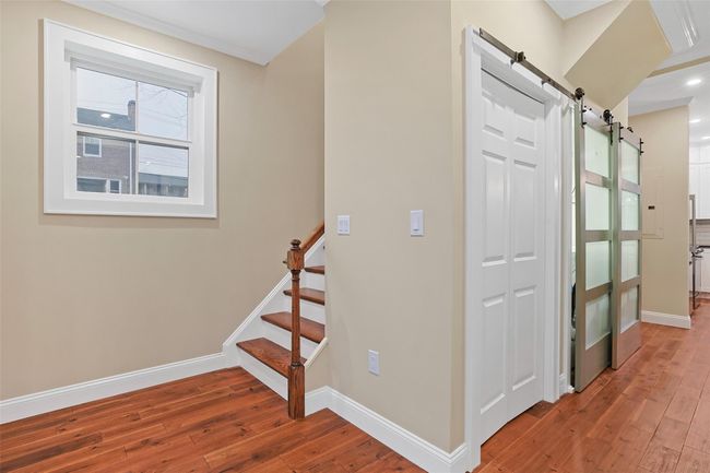 Coat closet and stairs to second floor. | Image 6