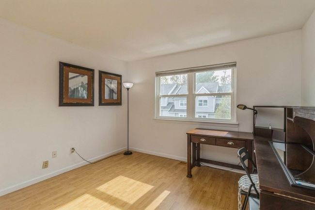 Bedroom with light wood finished floors ideal for office space | Image 18