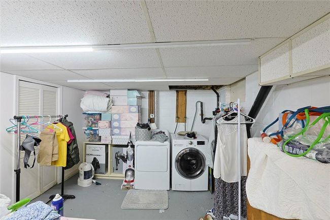 Laundry area in basement with closet for extra storage. | Image 17