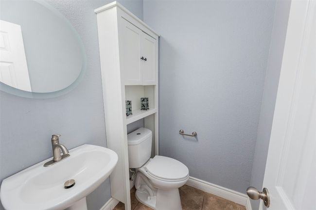Half bathroom featuring a sink and tile patterned flooring | Image 18